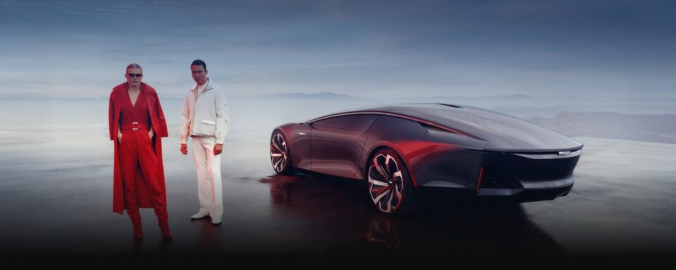 Duas pessoas em pé ao lado do Cadillac InnerSpace, destacando um design inovador e futurista.
